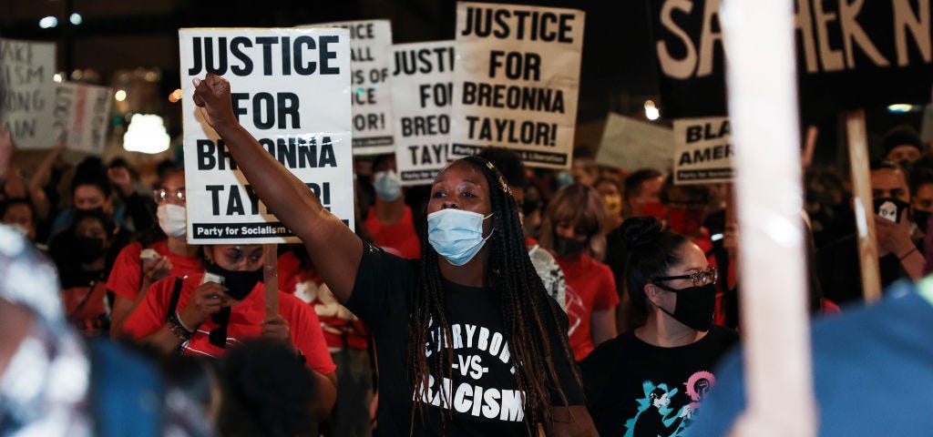 Black woman protesting the grand jury decision in Breonna Taylor’s case.