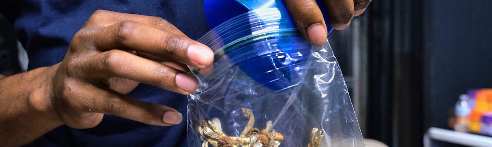 A vendor bags psilocybin mushrooms at a cannabis marketplace in Los Angeles on May 24, 2019.