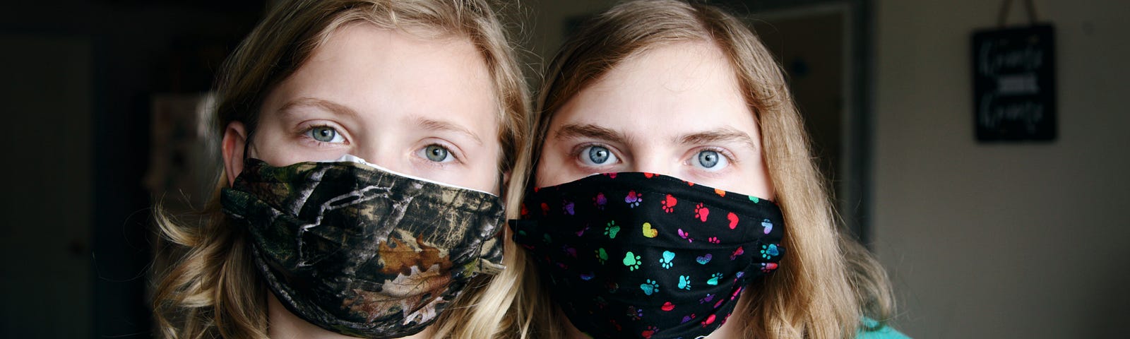 A woman and a girl wearing a facemask