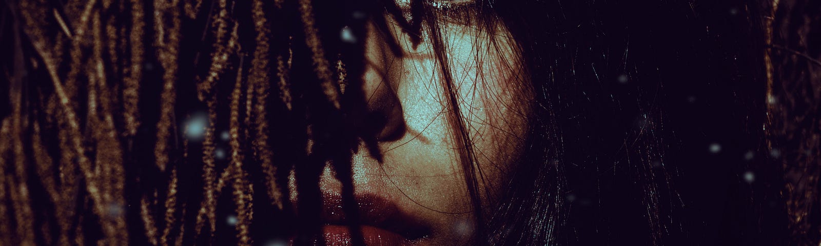 A woman with dreadlocks covering her face
