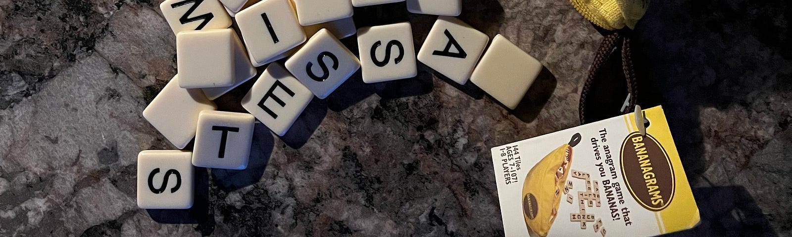 Bananagrams letter tiles spilling out from an unzipped cloth banana, featuring “Rules for Bananagrams,” and letter tiles spelling out “assets,” among the random spilled letter tiles.