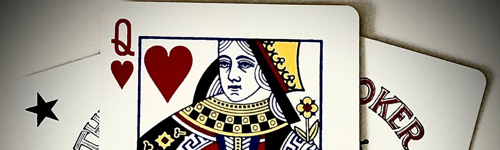 Queen of Hearts playing card flanked by two jokers