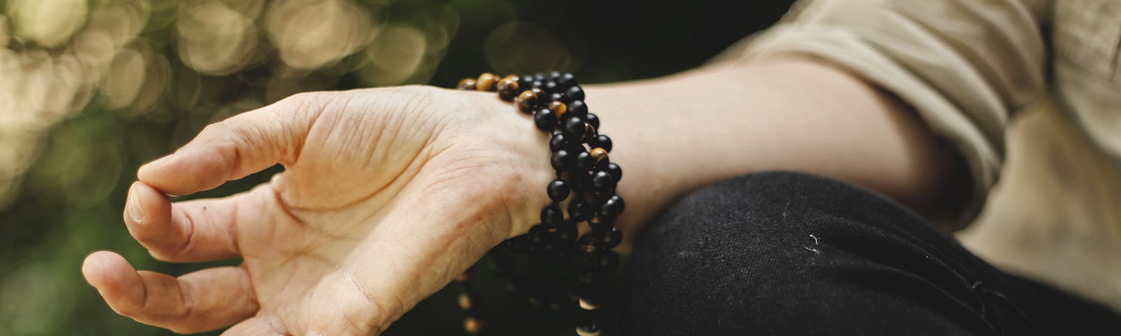 A closeup photo of the hand of someone meditating.