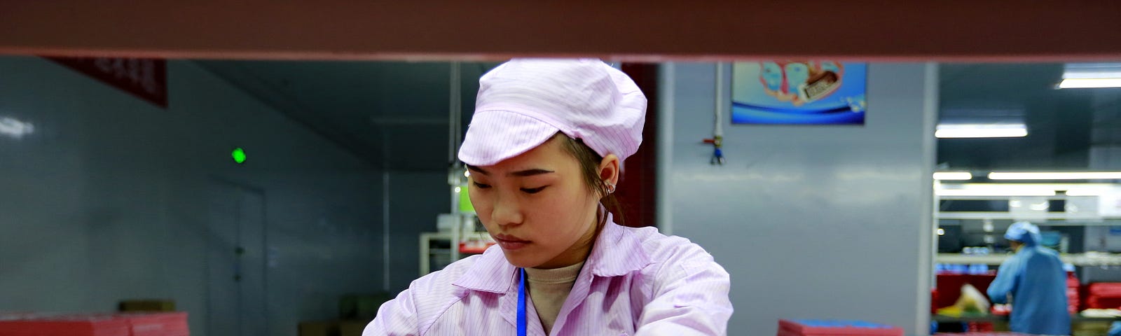 A woman worker assembles earphones for export in a factory in Suining in southwest China’s Sichuan province on Dec. 17, 2019.