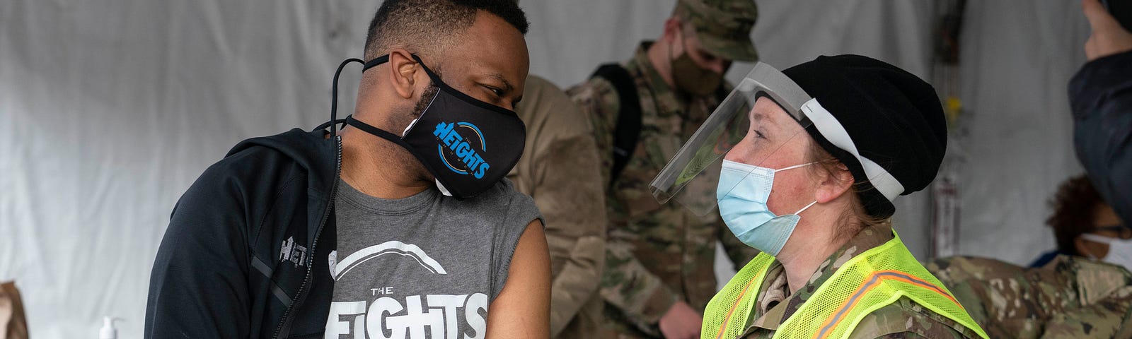 A man speaks with a member of the National Guard after receiving a coronavirus vaccine in the parking lot of Six Flags on February 6, 2021 in Bowie, Maryland.