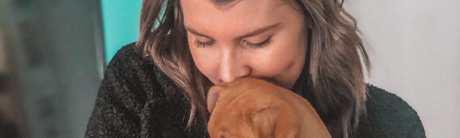 A photo of the author’s wife hugging their new puppy.
