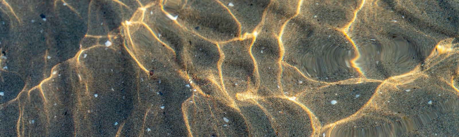 Ocean ripples and sand underwater.