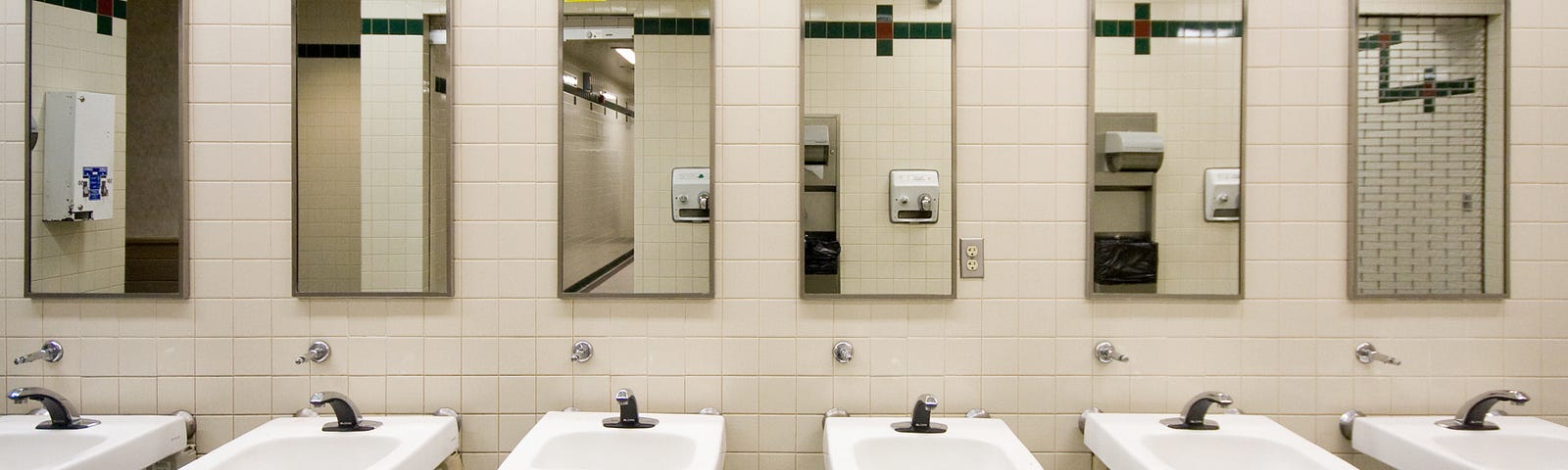 A view of the sinks and mirrors in a public bathroom.