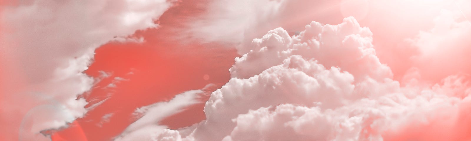 A photo of a pink tinted sky and clouds.