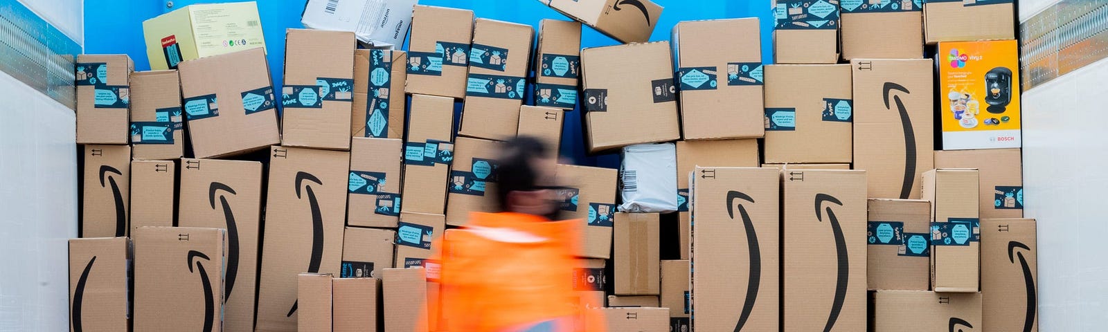 An Amazon worker among packages.