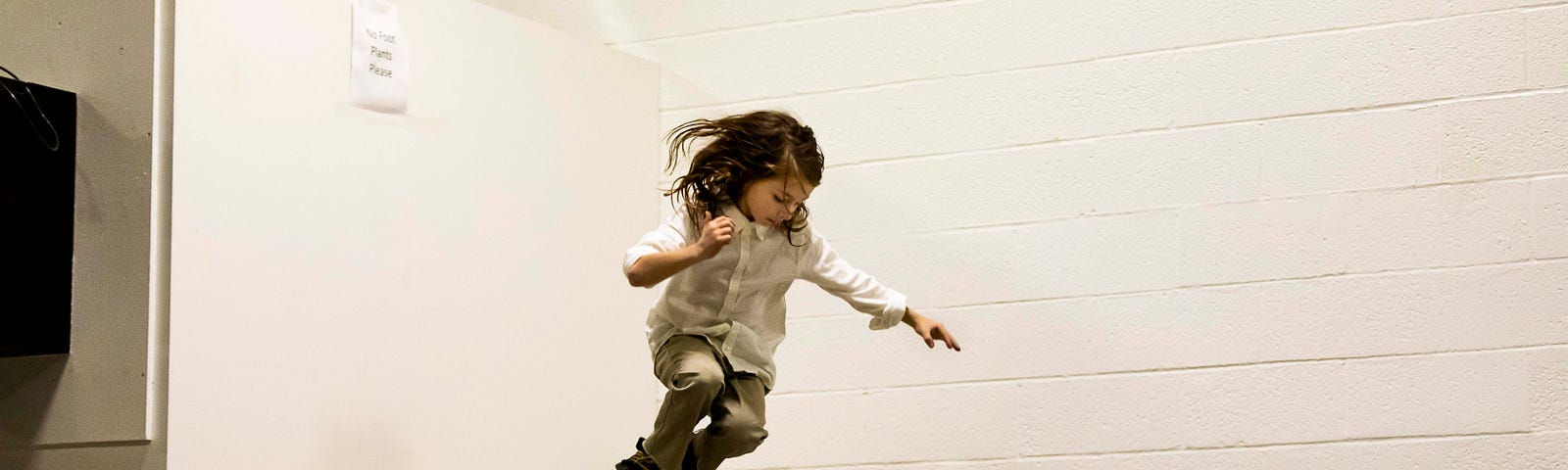 A photo of a young girl skateboarding on a ramp.