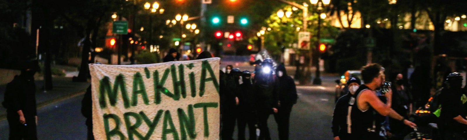 Protesters in Portland hold a sign to honor Ma’Khia Bryant, a Black girl who was fatally shot by a police officer in Columbus, Ohio.