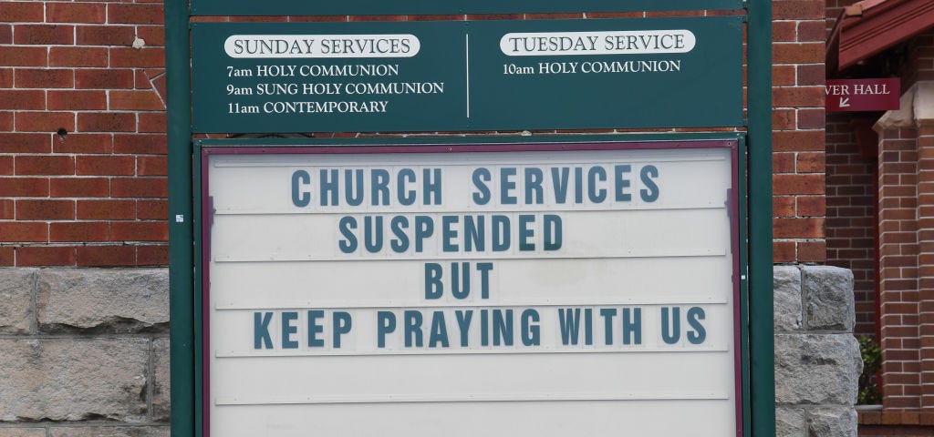 A sign outside a church that reads “Church services suspended by keep praying with us.”