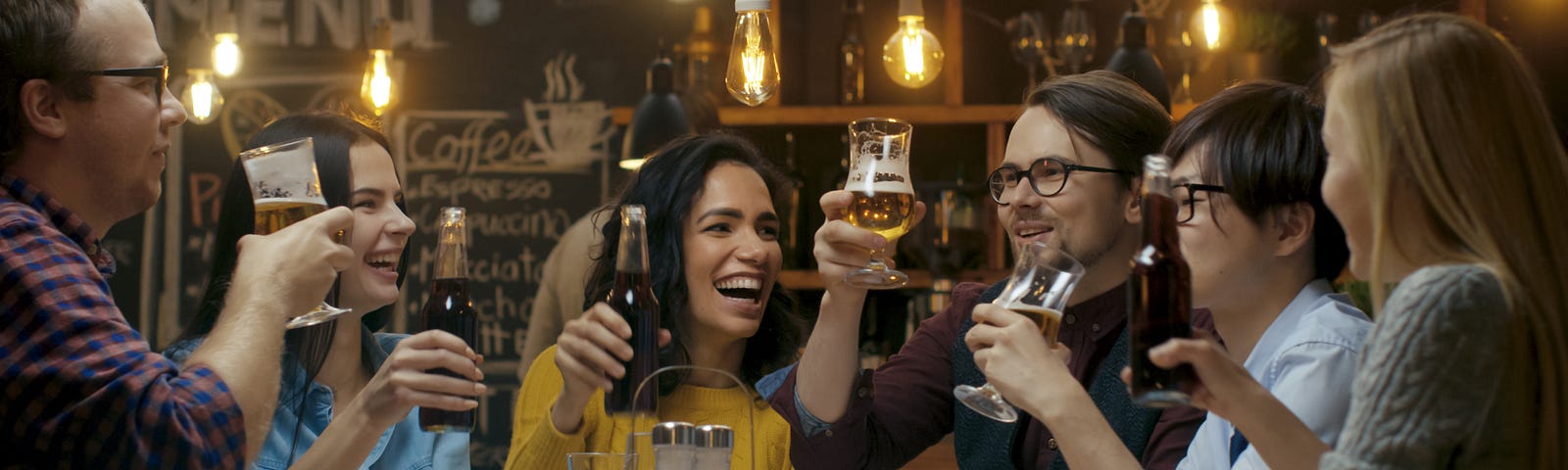 A group of friends celebrating  with a toast and raised glasses.