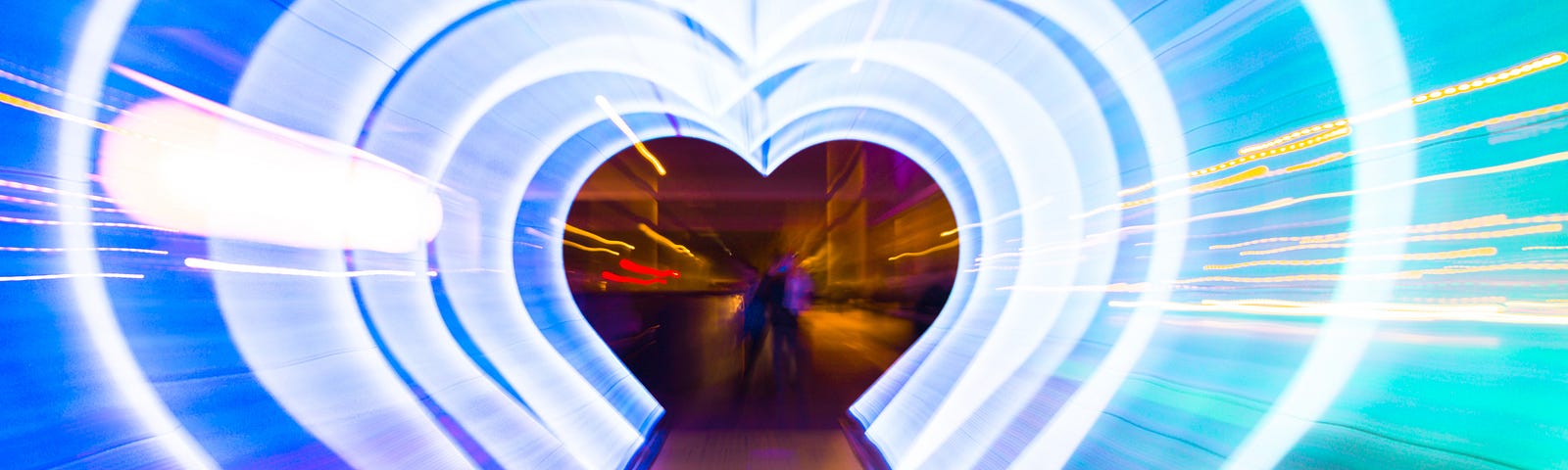 Creative picture with zoom technique of illuminated hearts creating tunnel effect with light trails.