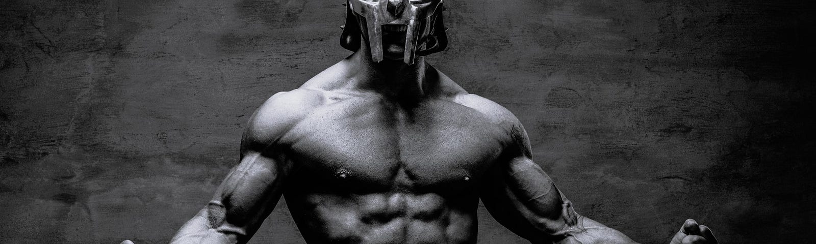 Image of a shirtless, muscleman in a metal mask in a “come and get me” stance with muscles flexed, looking fierce and ready to kill.