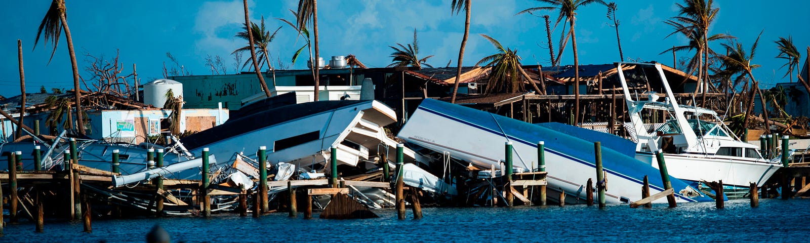 Photo of destroyed boats pushed up against the pier in the aftermath of Hurricane Dorian in Treasure Cay on Abaco Island.