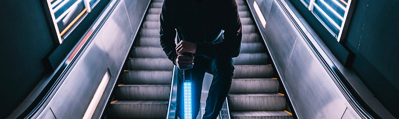 Decentralized Web 3.0 digital disruptor holding a Star Wars light saber in a subway stairway.