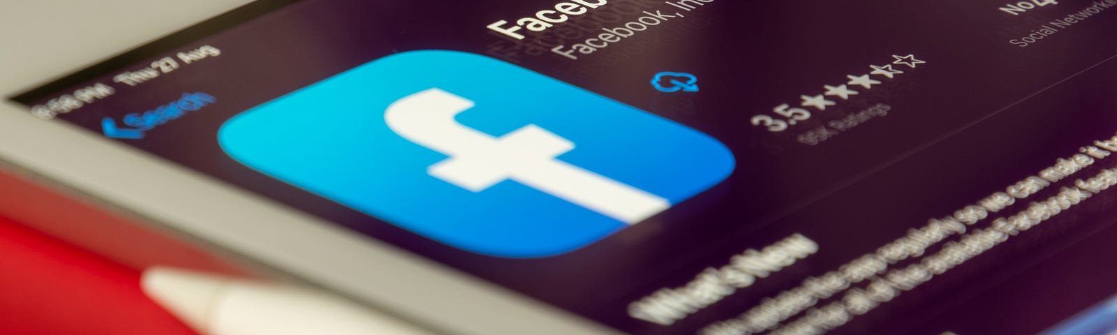 Image of a tablet with the Facebook app showing prominently.