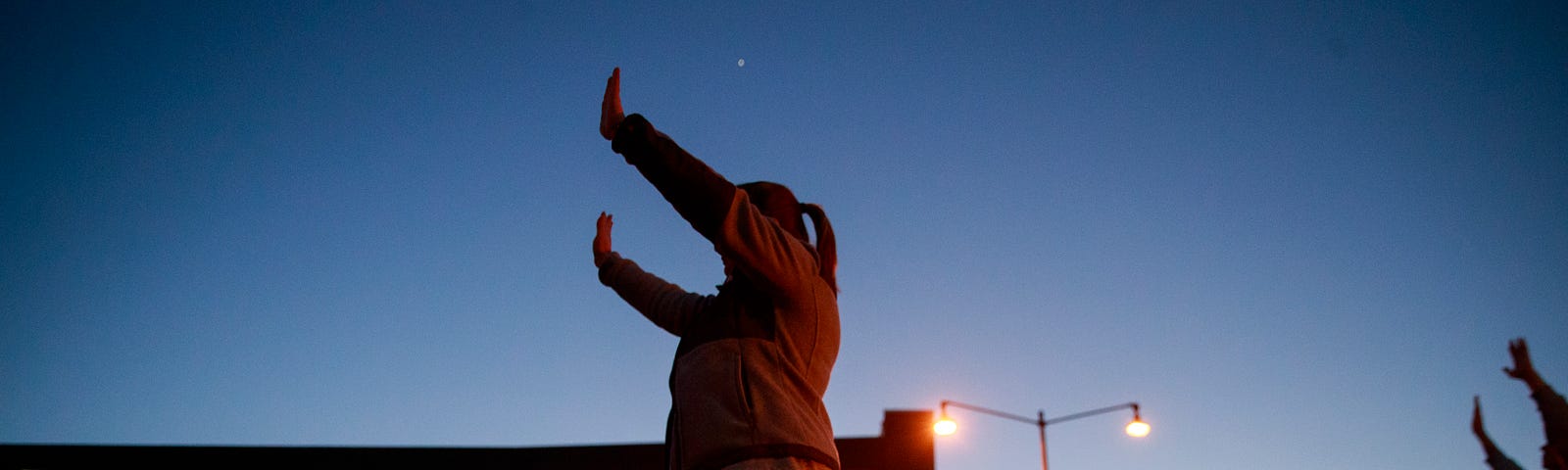 Members from the Lighthouse Fellowship Church gather on a Sunday night outside the Bloomington Hospital to pray for doctors,