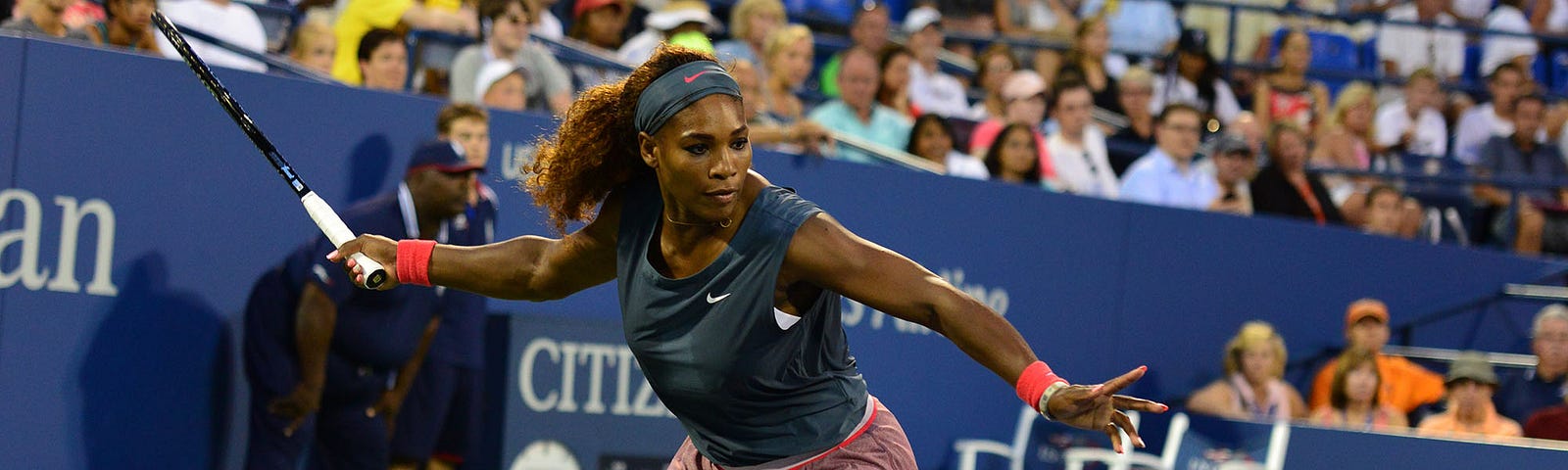 Serena Williams playing at the US Open 2013 about to hit a tennis ball