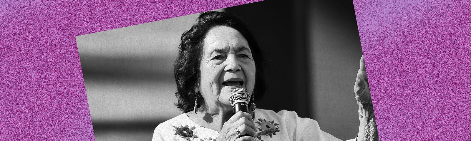 Black and white photo of Dolores Huerta against a violet background.
