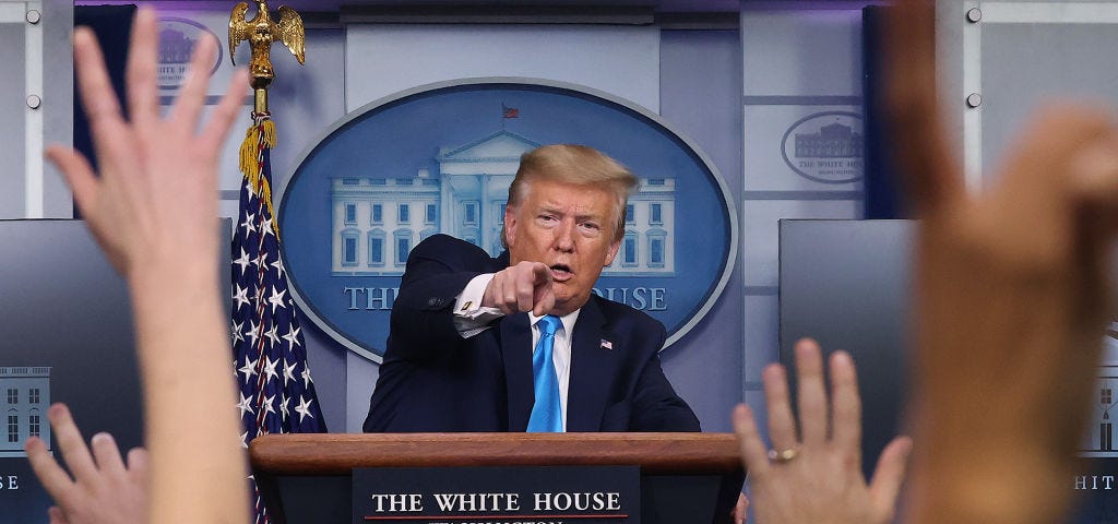 A photo of Donald Trump pointing at reporters’ raised hands at a meeting of the coronavirus task force at the White House.