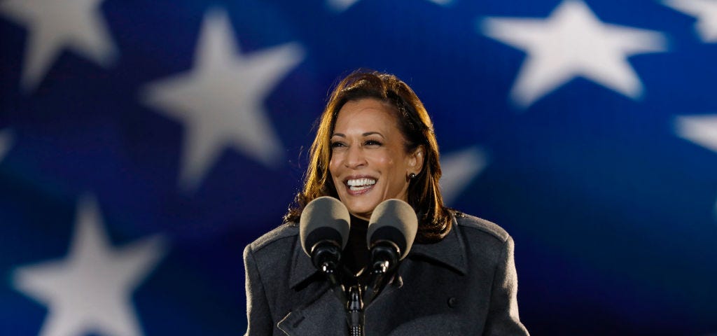 Kamala Harris giving a speech, she is smiling widely.