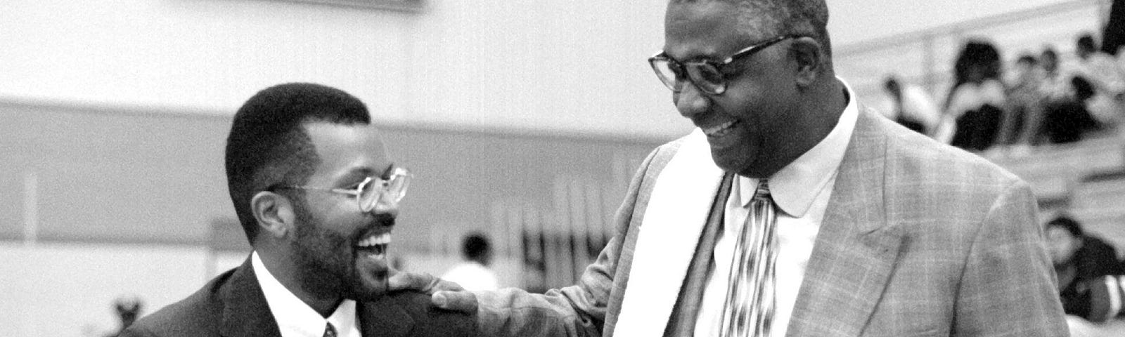 Coach Horace Broadnax (left) who played basketball for Georgetown meets with his old coach John Thompson before the game.