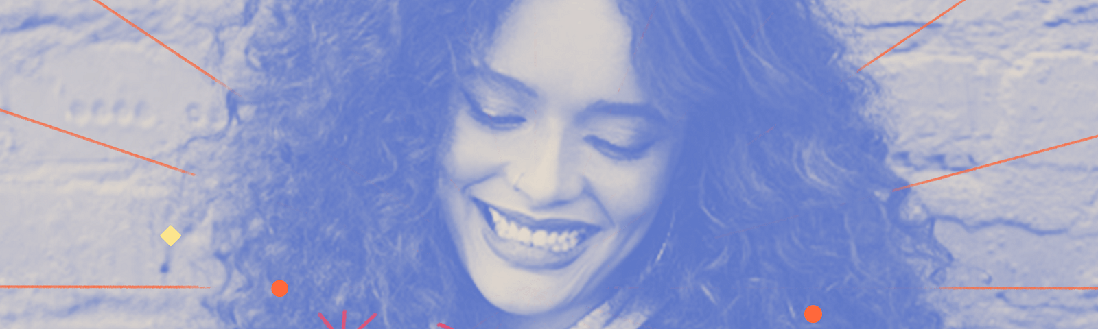 Blue filtered image of a woman with curly hair looking at her phone with a smile.