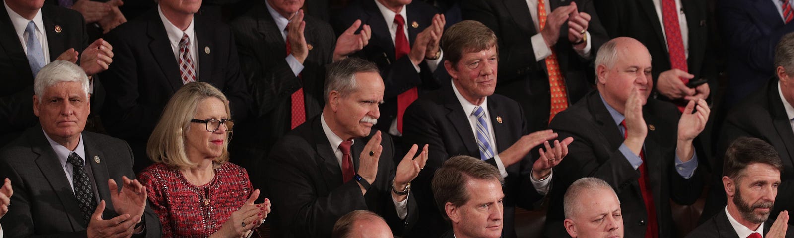 Lawmakers watch the State of the Union address in the chamber of the U.S. House of Representatives at the Capitol Building