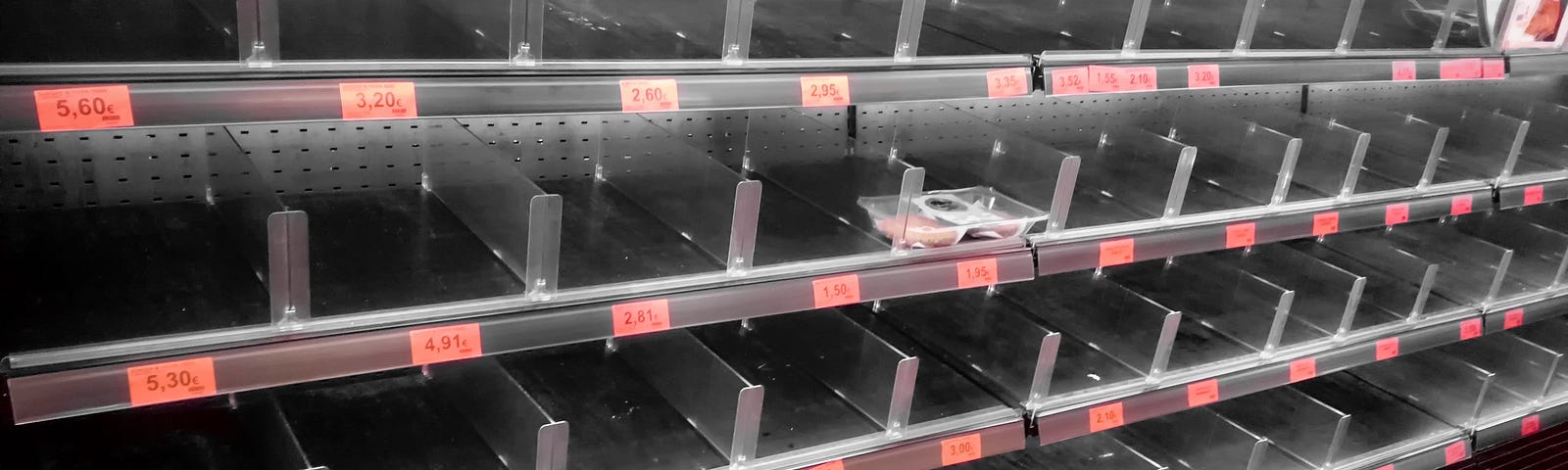 Empty meat shelves at the grocery store.