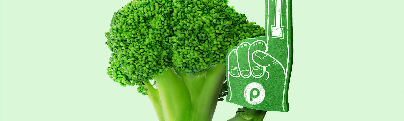 A stalk of broccoli holding up a green “#1” foam finger.