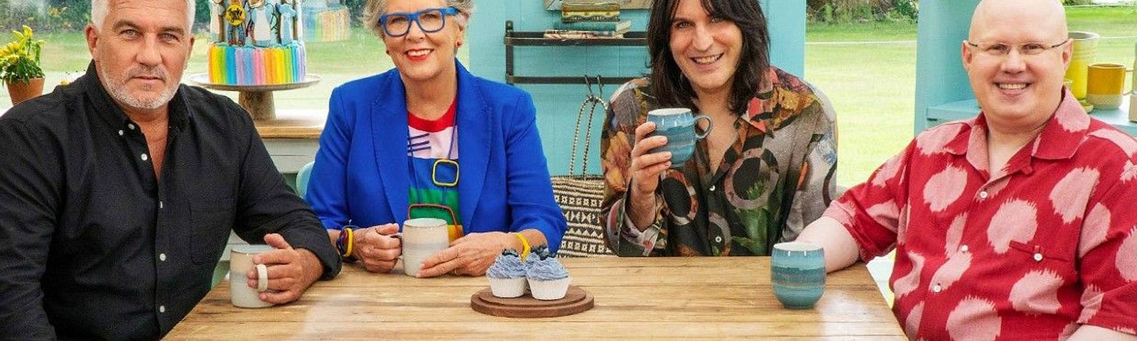 Paul Hollywood, Prue Leith, Noel Fielding, and Matt Lucas sitting at a table in the tent.