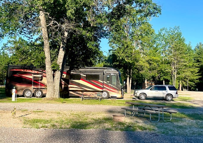 Picture of Charisse’s RV, parked at a campground.