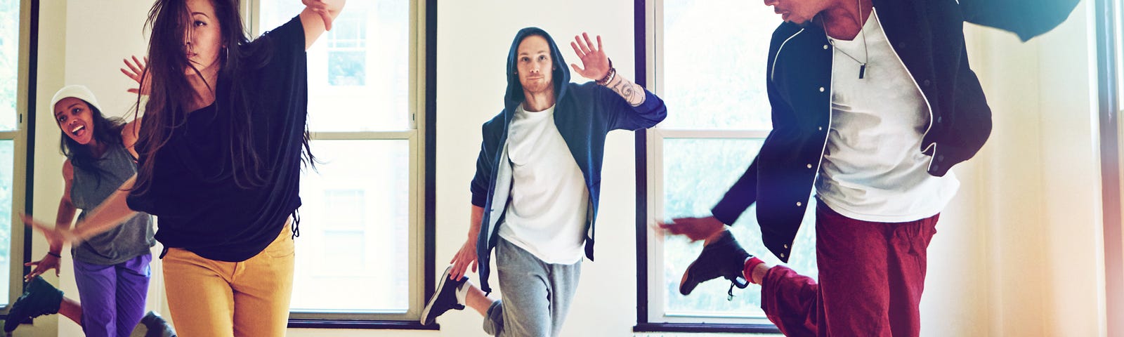 A group of young people dancing together in a studio