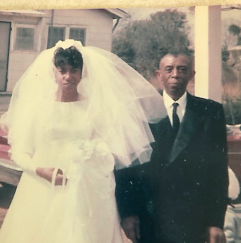 A vintage photo of Lillie Head with her father on her wedding day. She is wearing her wedding dress.