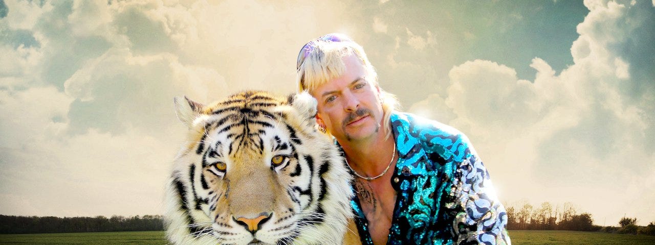 A promo still from Tiger King showing Joe Exotic with a tiger.