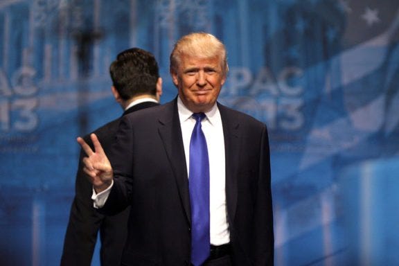 Donald Trump making a victory sign at CPAC.