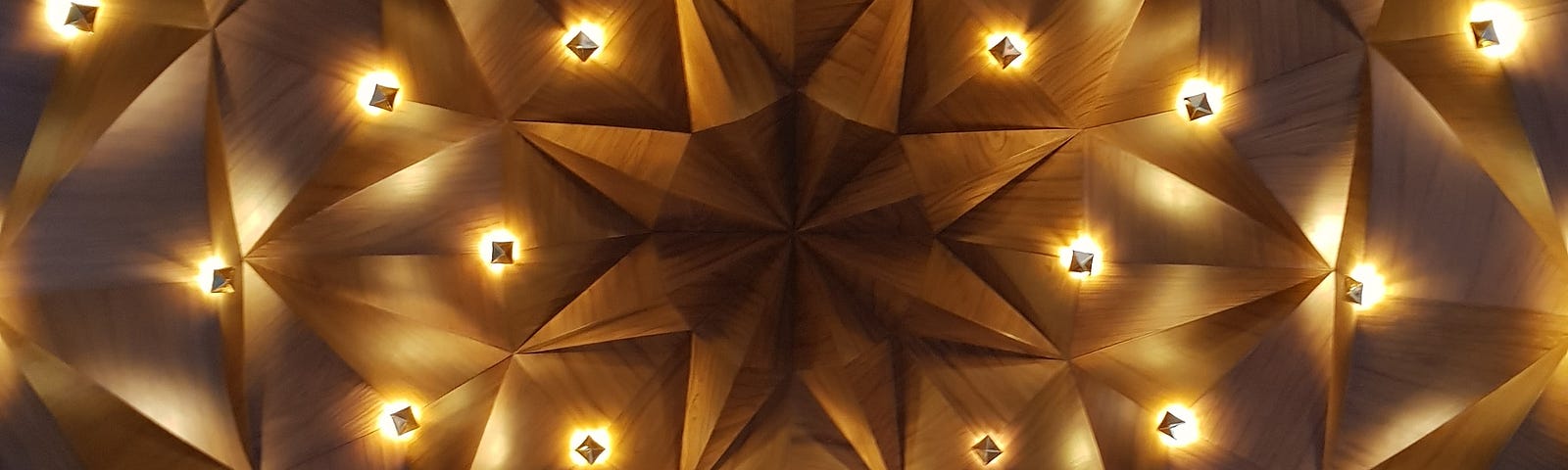 Wooden ceileing in mandala shape with lighting connecting lines as stars.