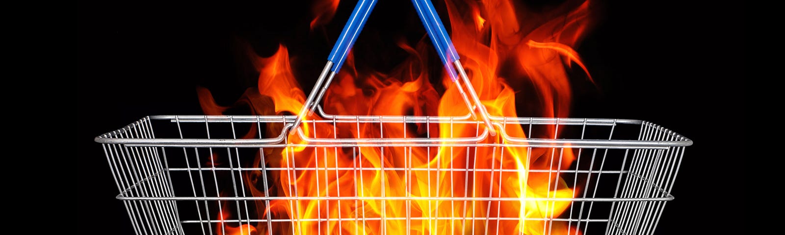 A wire shopping basket with flames inside against a black background.