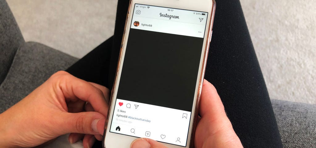 A photo of an Instagram post of a black square as part of #BlackOutTuesday.