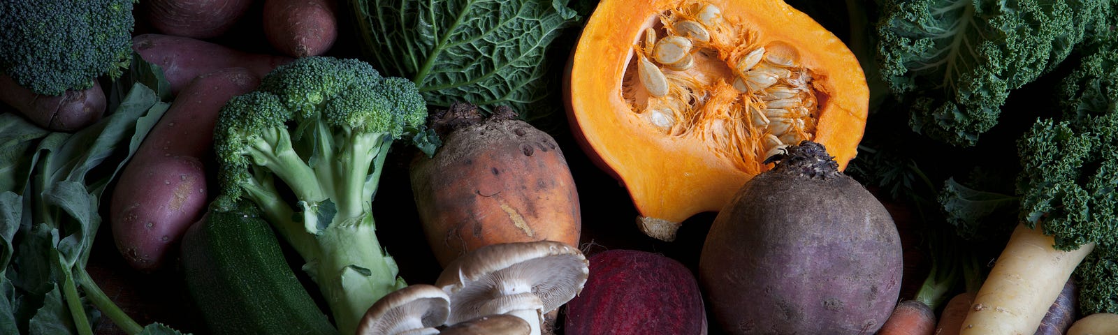 A bounty of fall vegetables like broccoli, parsnips, potatoes, mushrooms, and squash.