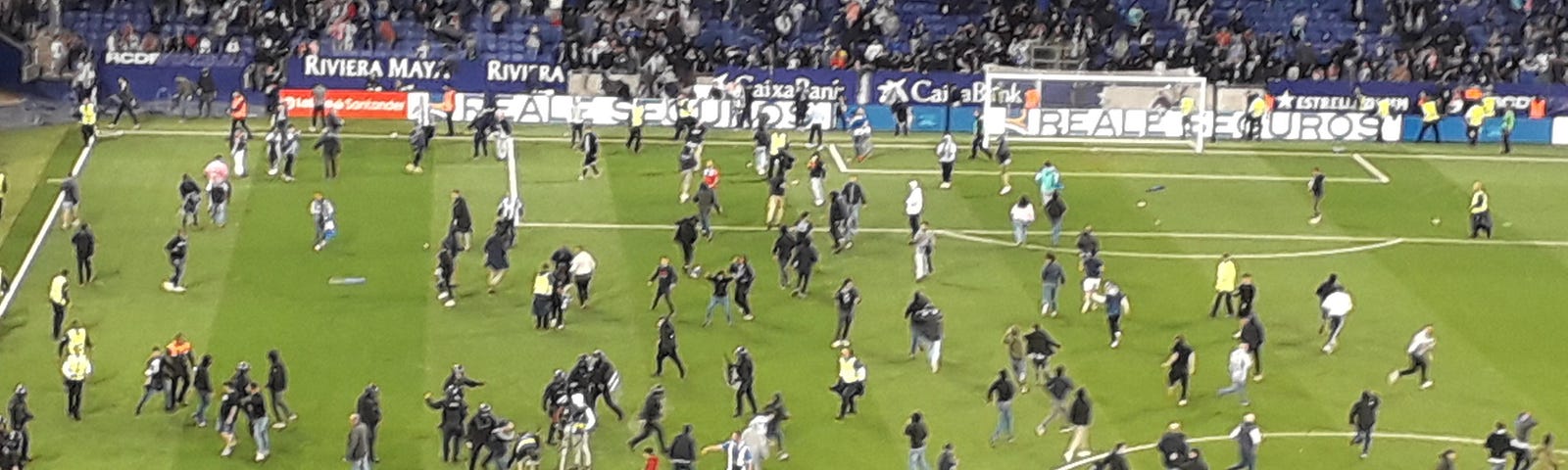 Football fans invade a pitch