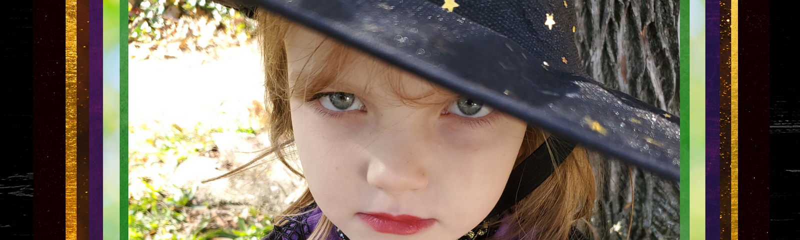 Close up of a little girl in a witch costume