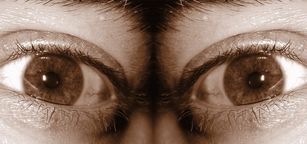 A sepia-tone mirrored image of someone’s eyeball.
