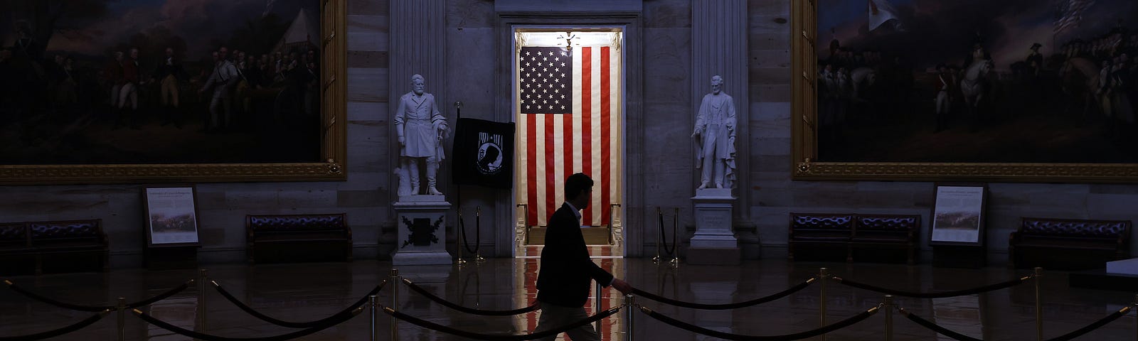 A man walks through the U.S. Capitol Rotunda, empty of tourists as only essential staff and journalists are allowed to work.