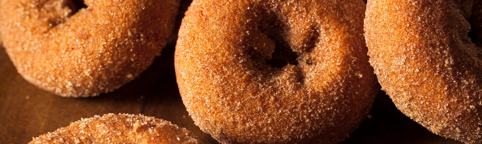 Cinnamon-sugar donuts on a table.