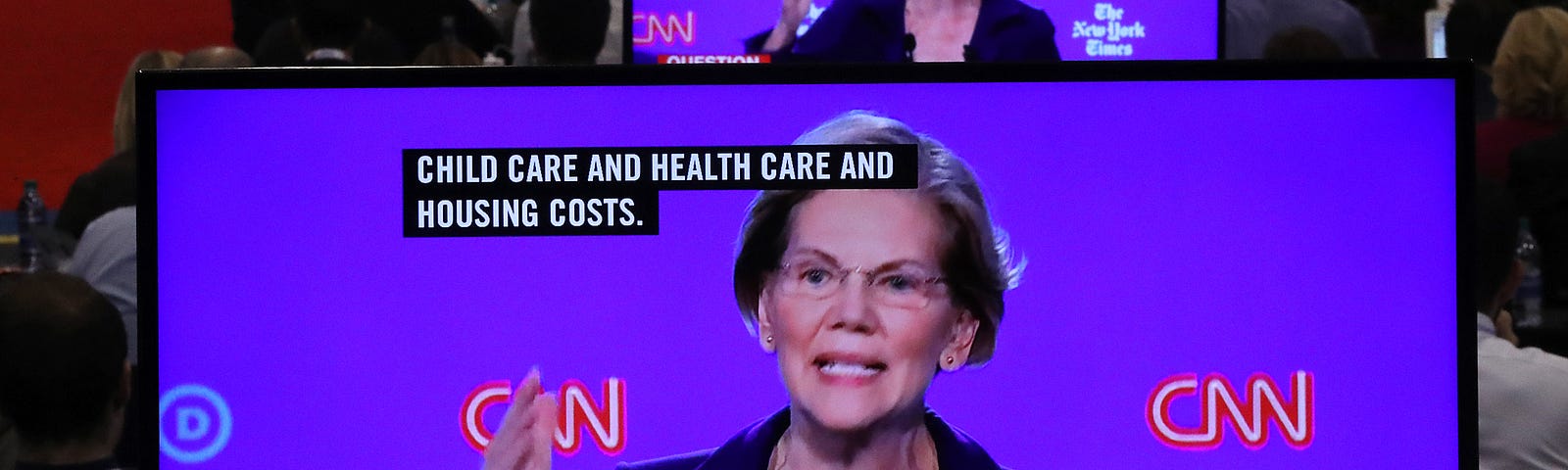 Sen. Elizabeth Warren (D-MA) appears on television screens in the Media Center during the Democratic Presidential Debate.