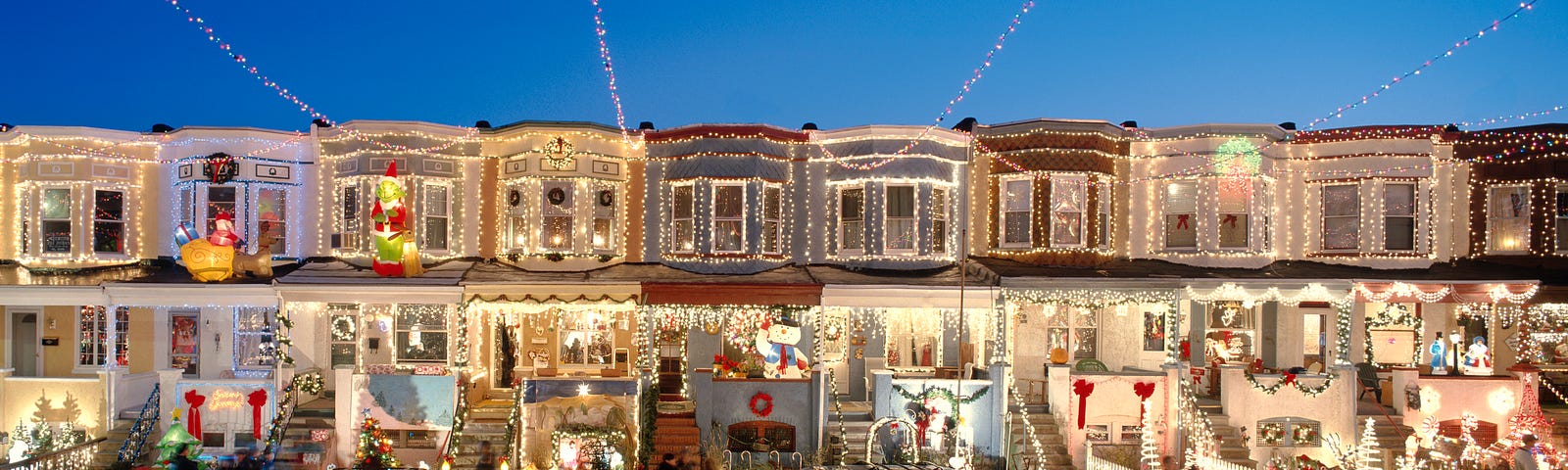 A row of houses with Christmas lighting